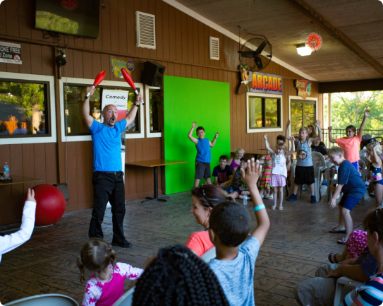 A man entertains a group of children