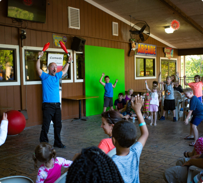 A man entertains a group of children