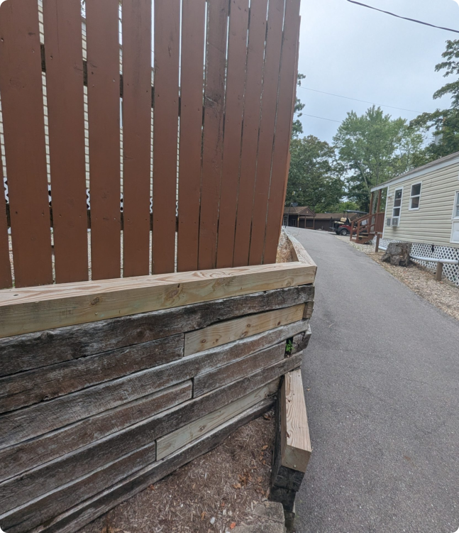 A wooden fence alongside a road