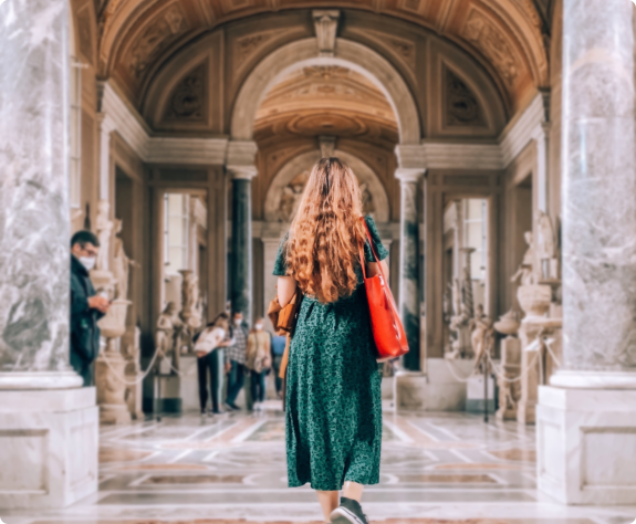A woman strolls through an art museum