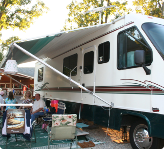 A white and green recreational vehicle parked