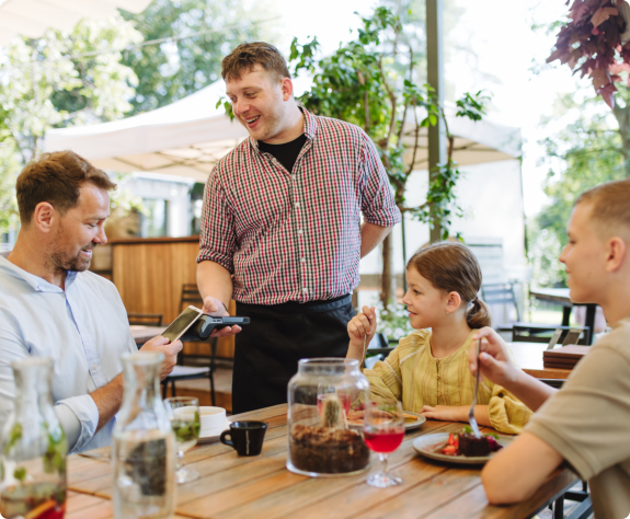 A man wearing a plaid shirt stands casually