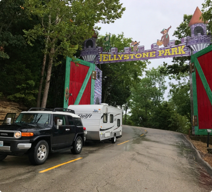 A truck parked by a gate with a "Belle Stone Park" sign