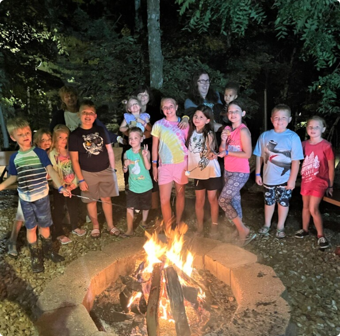Children standing in front of a campfire