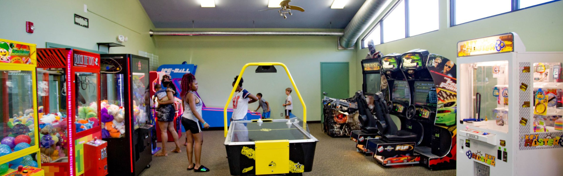 A vibrant game room filled with various arcade machines
